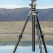 A Sony camera mounted on ROGETI RG-1 gear head and T32 Lite Plus tripod, set against a scenic background of a lake and mountains.