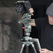 Professional photographer using a ROGETI RG-1 geared head and T32MAX geared tripod for precise indoor architecture photography, featuring exact leveling with spirit levels and precise height adjustments.